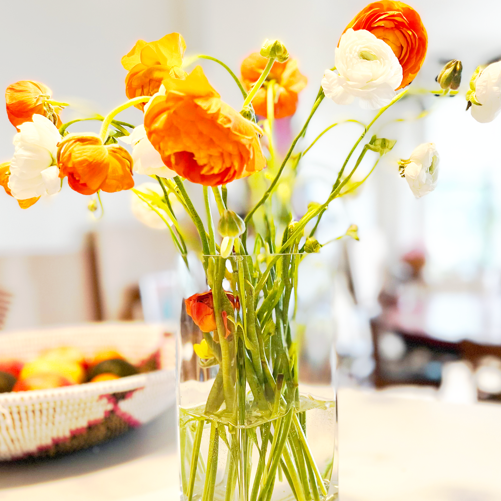 Flowers (ranunculus) in a glass vase.